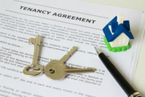 Tenancy agreement key and pen with symbolic miniature house